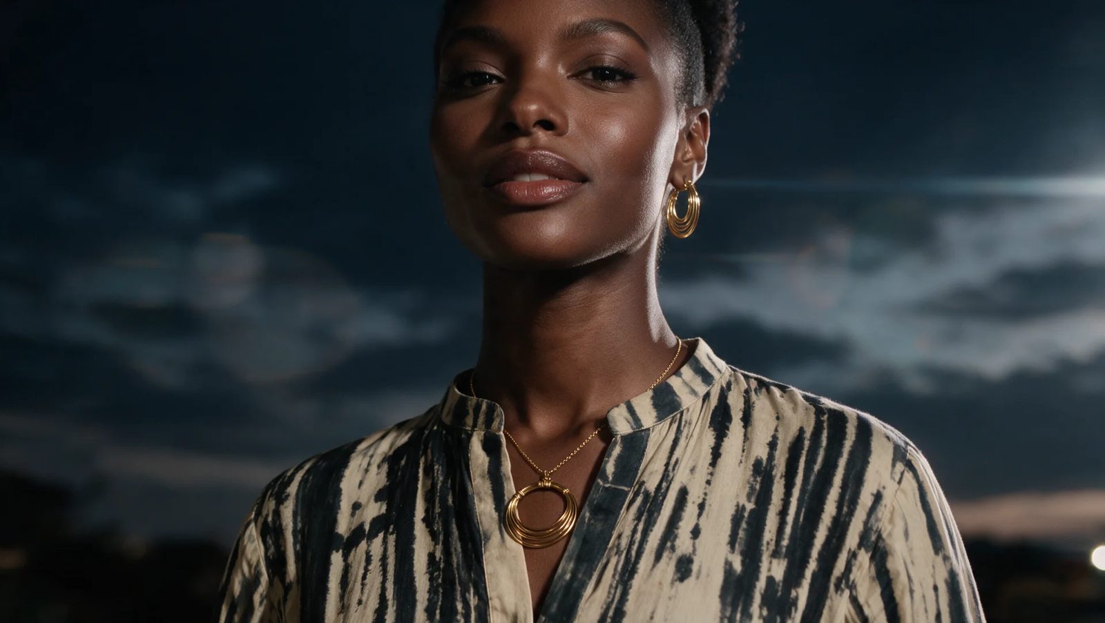 After: model wearing the gold hoop pendant and earrings at night